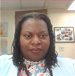 Photo of Dr Carmon, an African American woman with braids in a flowered shirt and sky blue jacket